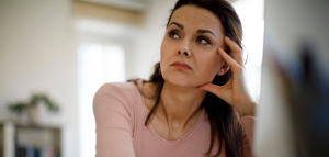 Woman sitting and thinking looking concerned