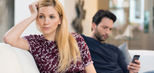 Husband ignoring wife on his phone