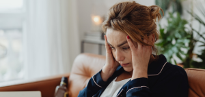 Woman with her head in her hands looking stressed out